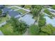 Aerial view of a single Gathering home, mature trees, fenced yard, and neighborhood at 6203 Candlewood Ln, Orlando, FL 32809