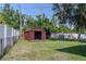 Large backyard with lawn, storage shed, and fenced perimeter at 6203 Candlewood Ln, Orlando, FL 32809
