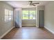 Bright bedroom with wood floors and two closets that flank a large window at 6203 Candlewood Ln, Orlando, FL 32809