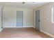 Spacious bedroom features modern flooring and two gray paneled doors at 6203 Candlewood Ln, Orlando, FL 32809
