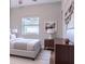 Bright bedroom featuring neutral walls and wood floors at 6203 Candlewood Ln, Orlando, FL 32809
