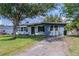 Quaint single-story home featuring a well-manicured front yard and a welcoming entrance at 6203 Candlewood Ln, Orlando, FL 32809