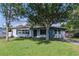 Charming single-story home with a well-maintained lawn, mature trees, and classic curb appeal at 6203 Candlewood Ln, Orlando, FL 32809