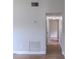 Long hallway featuring wood-look flooring and access to rooms at 6203 Candlewood Ln, Orlando, FL 32809