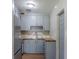 A cozy kitchen featuring light blue cabinets, stainless steel appliances, and butcher block countertops at 6203 Candlewood Ln, Orlando, FL 32809