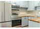 Well-lit kitchen with stainless steel appliances and warm wood countertops at 6203 Candlewood Ln, Orlando, FL 32809