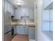 An updated kitchen featuring stainless steel appliances, blue cabinets, and butcher block countertops at 6203 Candlewood Ln, Orlando, FL 32809