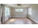 Spacious living room boasting hardwood floors, ample natural light, and a modern ceiling fan at 6203 Candlewood Ln, Orlando, FL 32809