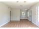 Hardwood floor living room with a ceiling fan, neutral walls, and an open floor plan at 6203 Candlewood Ln, Orlando, FL 32809