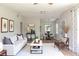 Open-concept living area flowing into dining space, featuring hardwood floors, and neutral decor at 6203 Candlewood Ln, Orlando, FL 32809
