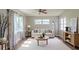 Bright living room featuring neutral walls, modern furniture, and large windows with patterned curtains at 6203 Candlewood Ln, Orlando, FL 32809
