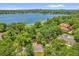 Stunning aerial showcasing lakefront homes nestled among lush trees, and serene neighborhood setting at 633 Balmoral Rd, Winter Park, FL 32789