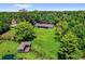 Aerial view of estate, highlighting the private backyard, dock, mature trees, and lush landscaping at 633 Balmoral Rd, Winter Park, FL 32789