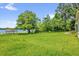 Expansive backyard features a large grassy area and mature trees offering serene privacy at 633 Balmoral Rd, Winter Park, FL 32789