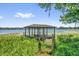 Dock and gazebo on a lake filled with lily pads at 633 Balmoral Rd, Winter Park, FL 32789