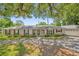 Charming single-story home with a mature landscaped front yard and red window shutters at 633 Balmoral Rd, Winter Park, FL 32789