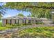 Charming single-story home with a mature landscaped front yard and red window shutters at 633 Balmoral Rd, Winter Park, FL 32789
