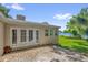 Rear exterior view of home with brick patio and French doors leading to backyard at 633 Balmoral Rd, Winter Park, FL 32789