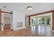 Living room with tile flooring, painted brick fireplace, and lake view through windows at 633 Balmoral Rd, Winter Park, FL 32789