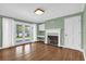 Cozy living room with hardwood floors, a fireplace, and French doors at 633 Balmoral Rd, Winter Park, FL 32789
