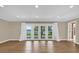 Spacious living room with wood floors and doors leading to the backyard and lake at 633 Balmoral Rd, Winter Park, FL 32789