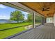 Screened-in porch with wood flooring and ceiling fans overlooking lake view at 633 Balmoral Rd, Winter Park, FL 32789