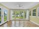 Bright sunroom with tile floor, many windows and a ceiling fan at 633 Balmoral Rd, Winter Park, FL 32789
