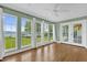 Bright sunroom with hardwood floors, many windows and a ceiling fan at 633 Balmoral Rd, Winter Park, FL 32789