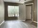 Neutral bedroom with new wood-look floors has plentiful natural light and two entry doors at 6400 Raleigh St # 3015, Orlando, FL 32835