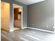 This bedroom features durable wood-look flooring and a glimpse into the attached bath at 6400 Raleigh St # 3015, Orlando, FL 32835
