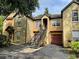 Townhome complex with garage parking, second-story entry, and colorful garden at 6400 Raleigh St # 3015, Orlando, FL 32835