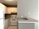 Cozy kitchen featuring white appliances, ample cabinetry, and a convenient breakfast bar area at 6400 Raleigh St # 3015, Orlando, FL 32835