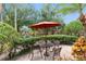 Outdoor patio with comfortable seating, umbrella, and views of the community and pool at 6400 Raleigh St # 3015, Orlando, FL 32835