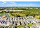 This aerial shot shows the home situated within a vibrant community near a serene lake and wooded area at 7745 Somersworth Dr, Kissimmee, FL 34747