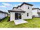 The backyard features a sliding door, grassy area, and a concrete patio at 7745 Somersworth Dr, Kissimmee, FL 34747