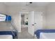 Bedroom featuring bunkbeds, twin beds, ceiling fan, and an open doorway to the upstairs landing at 7745 Somersworth Dr, Kissimmee, FL 34747