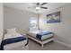 Cozy bedroom with twin beds, soft carpet, and a tranquil atmosphere perfect for relaxation at 7745 Somersworth Dr, Kissimmee, FL 34747