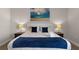 Cozy bedroom featuring plush bed, stylish lamps, and a serene painting at 7745 Somersworth Dr, Kissimmee, FL 34747