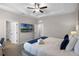 Bedroom featuring bed with soft bedding and a wall-mounted TV with multiple doorways at 7745 Somersworth Dr, Kissimmee, FL 34747