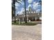 Clubhouse entrance showcasing manicured landscaping, elegant architecture, and convenient access at 7745 Somersworth Dr, Kissimmee, FL 34747