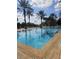 Resort-style community pool surrounded by palm trees, ideal for leisure and recreation at 7745 Somersworth Dr, Kissimmee, FL 34747