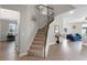Inviting entryway with hardwood floors, a staircase with decorative railing, and views into the living spaces at 7745 Somersworth Dr, Kissimmee, FL 34747