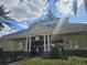 Attractive building exterior with a covered entrance, columns and well-maintained landscaping at 7745 Somersworth Dr, Kissimmee, FL 34747