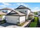 Charming two-story home featuring an attached two-car garage and walkway leading to the front door at 7745 Somersworth Dr, Kissimmee, FL 34747