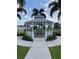 Picturesque white gazebo surrounded by lush greenery and palm trees providing a tranquil retreat at 7745 Somersworth Dr, Kissimmee, FL 34747