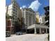 Grand hotel exterior featuring multiple balconies, lush landscaping, and convenient parking at 7745 Somersworth Dr, Kissimmee, FL 34747