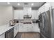 Contemporary kitchen features stainless steel appliances, white cabinetry and stylish tile backsplash at 7745 Somersworth Dr, Kissimmee, FL 34747