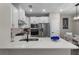 Kitchen featuring stainless steel appliances, white cabinetry, quartz countertops, and stylish decor at 7745 Somersworth Dr, Kissimmee, FL 34747