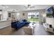 Bright living room with a view of the backyard through sliding glass doors, wood-look floors, and modern decor at 7745 Somersworth Dr, Kissimmee, FL 34747