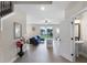 Open-concept living room with wood-look floors, modern furnishings, and a view of the backyard at 7745 Somersworth Dr, Kissimmee, FL 34747